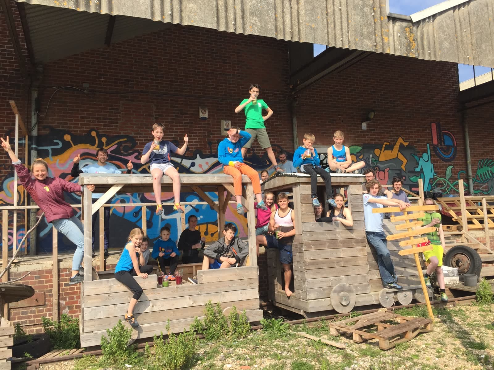 A crowd of young climbers and parents cheering outside the Shack