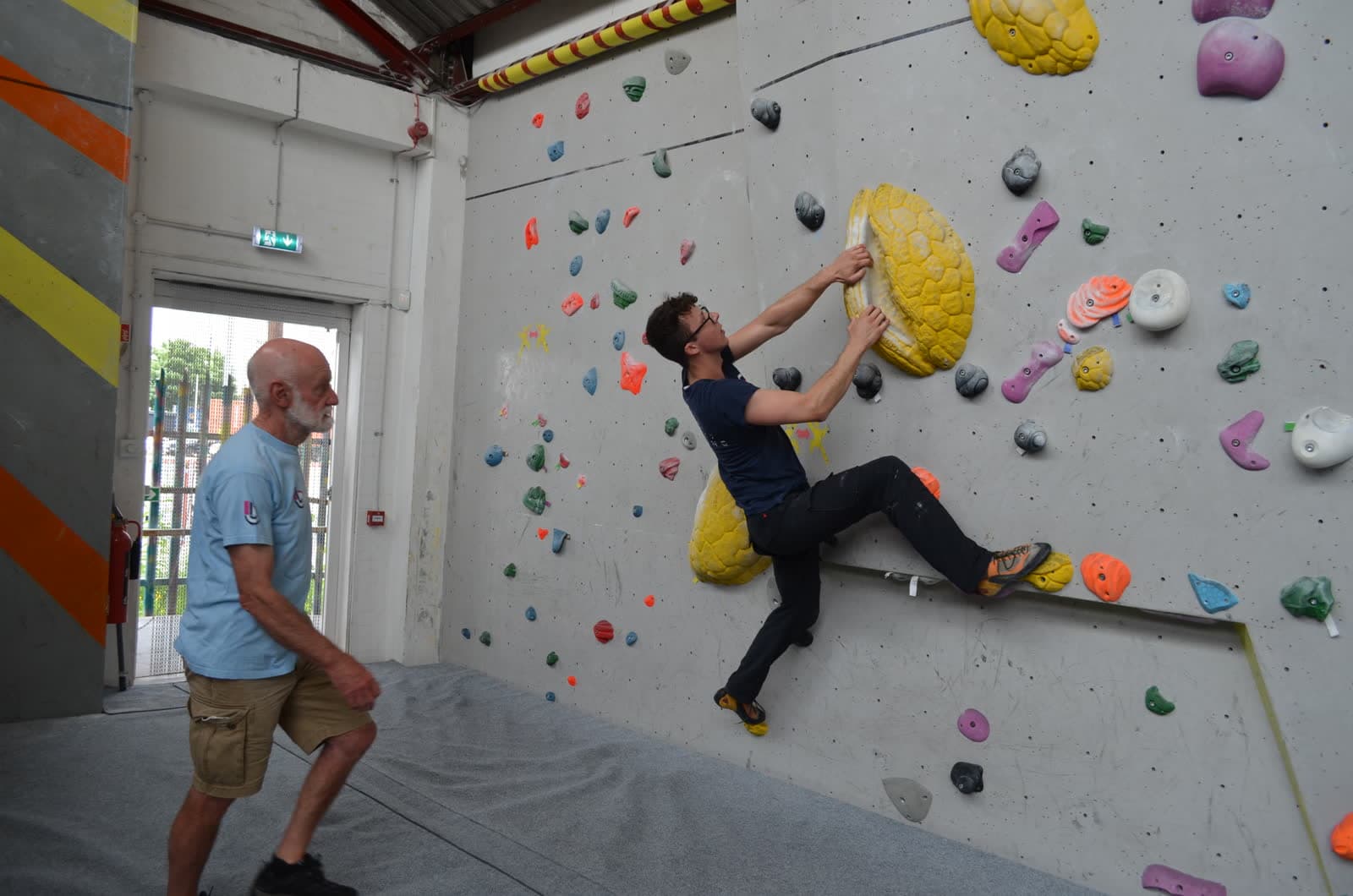 A first timer on the wall with a coach close by