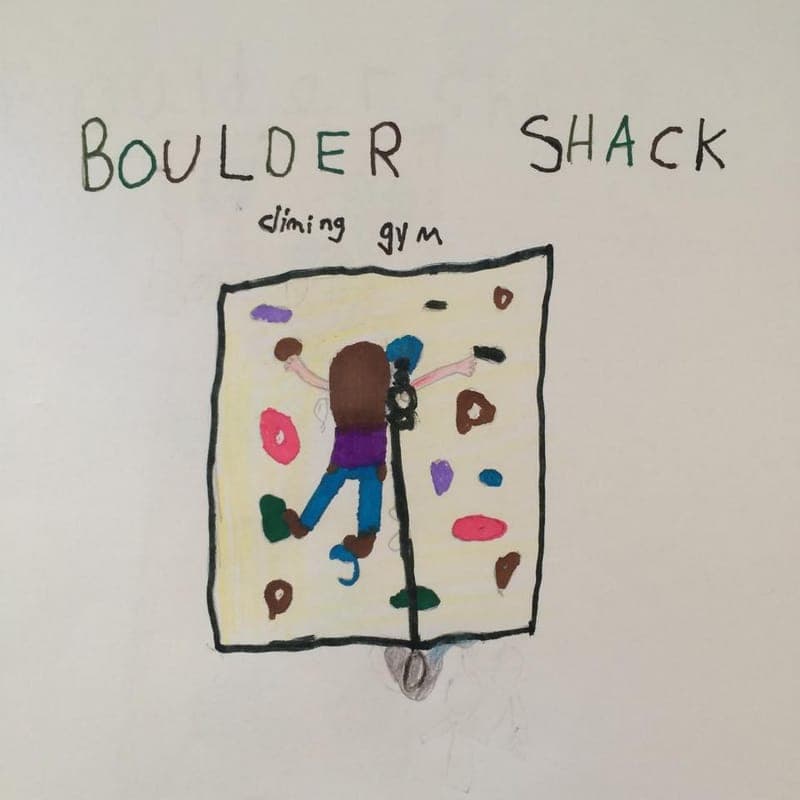 A child’s drawing of a climber on a wall under the words Boulder Shack
