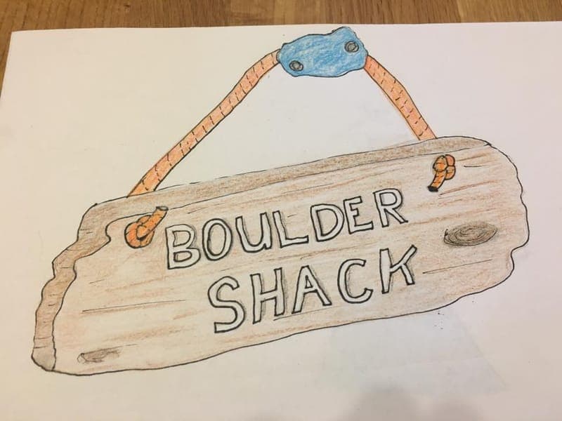 A pencil drawing of a wooden sign hanging from a climbing hold