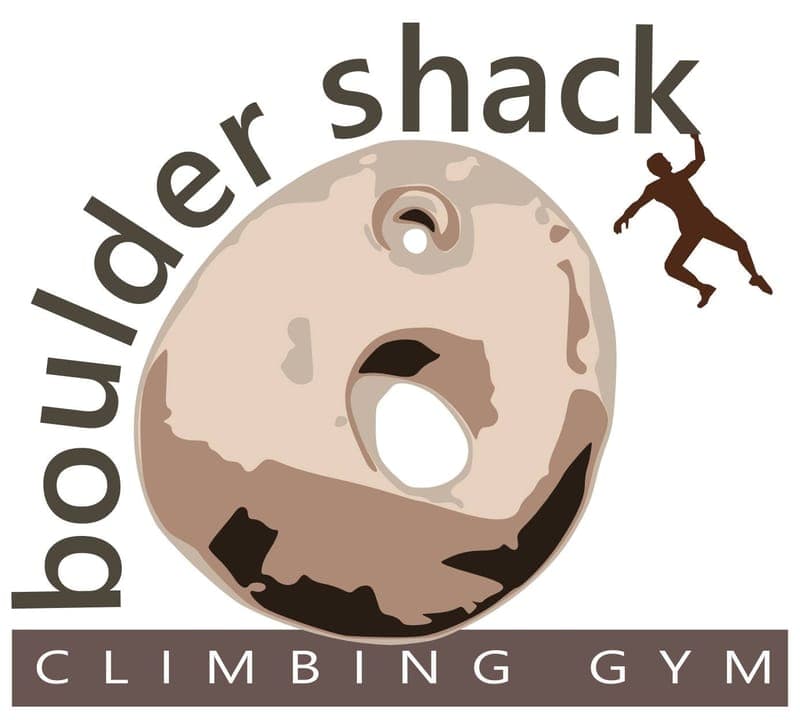 A logo with a climber hanging off a large round hold