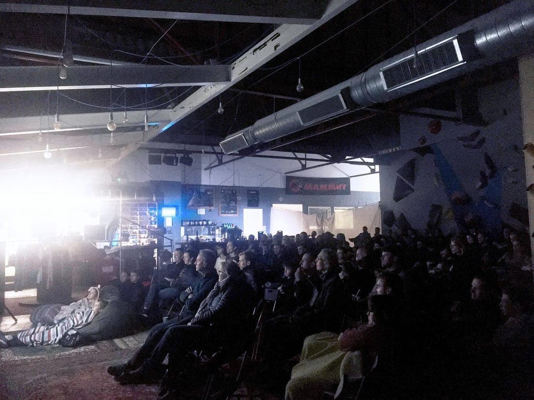 A film night, the mats full of people watching a screen