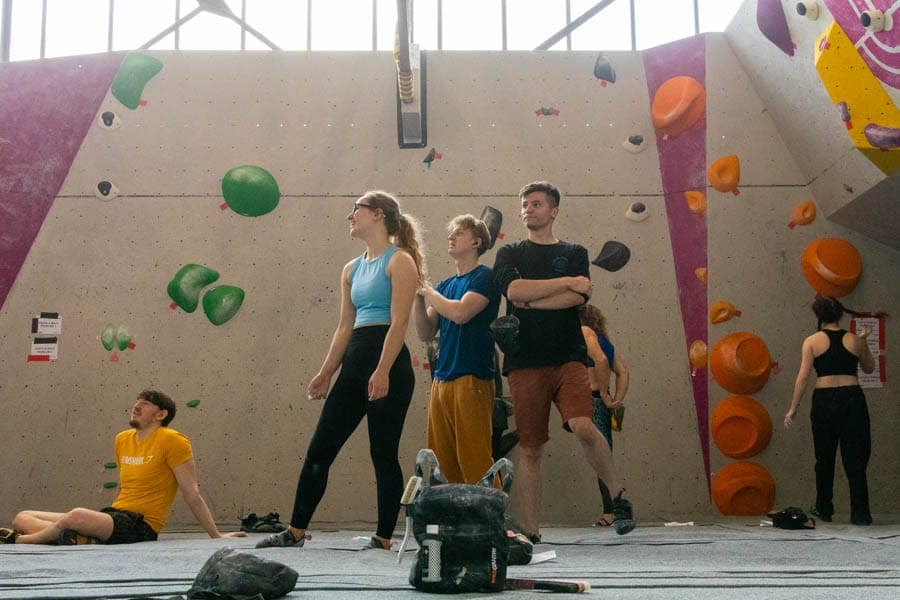 A group of climbers talking between attempts at a competition