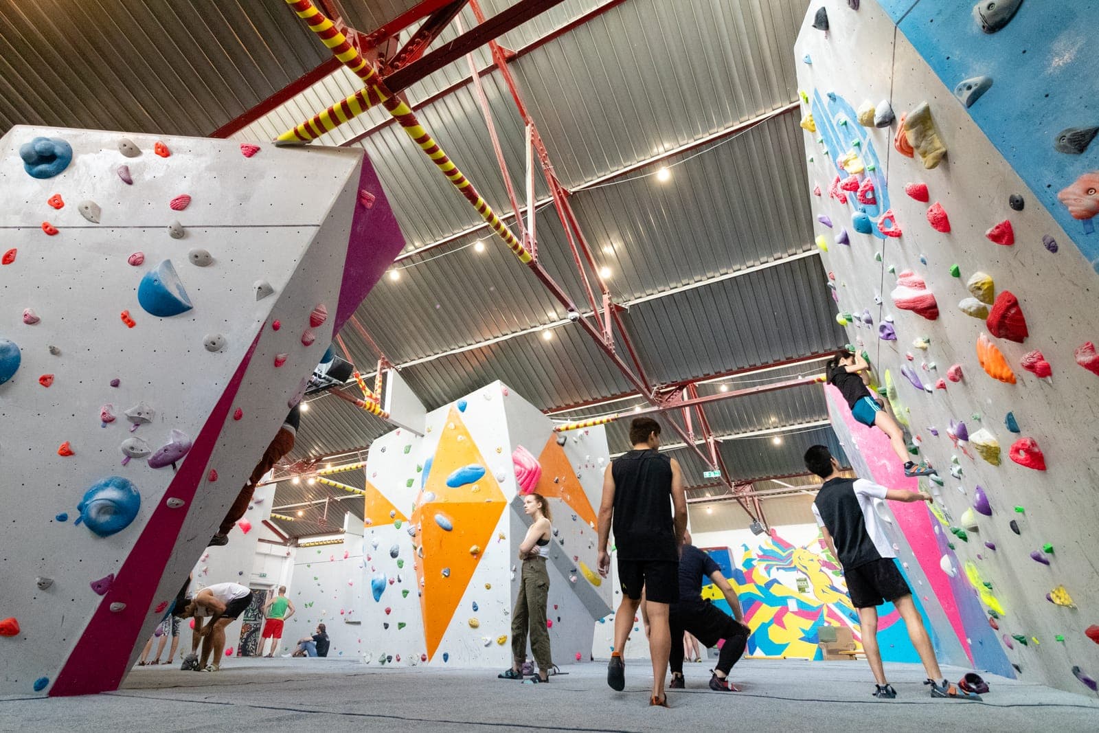 Climbers standing between the walls at Boulder Shack, looking up at the problems