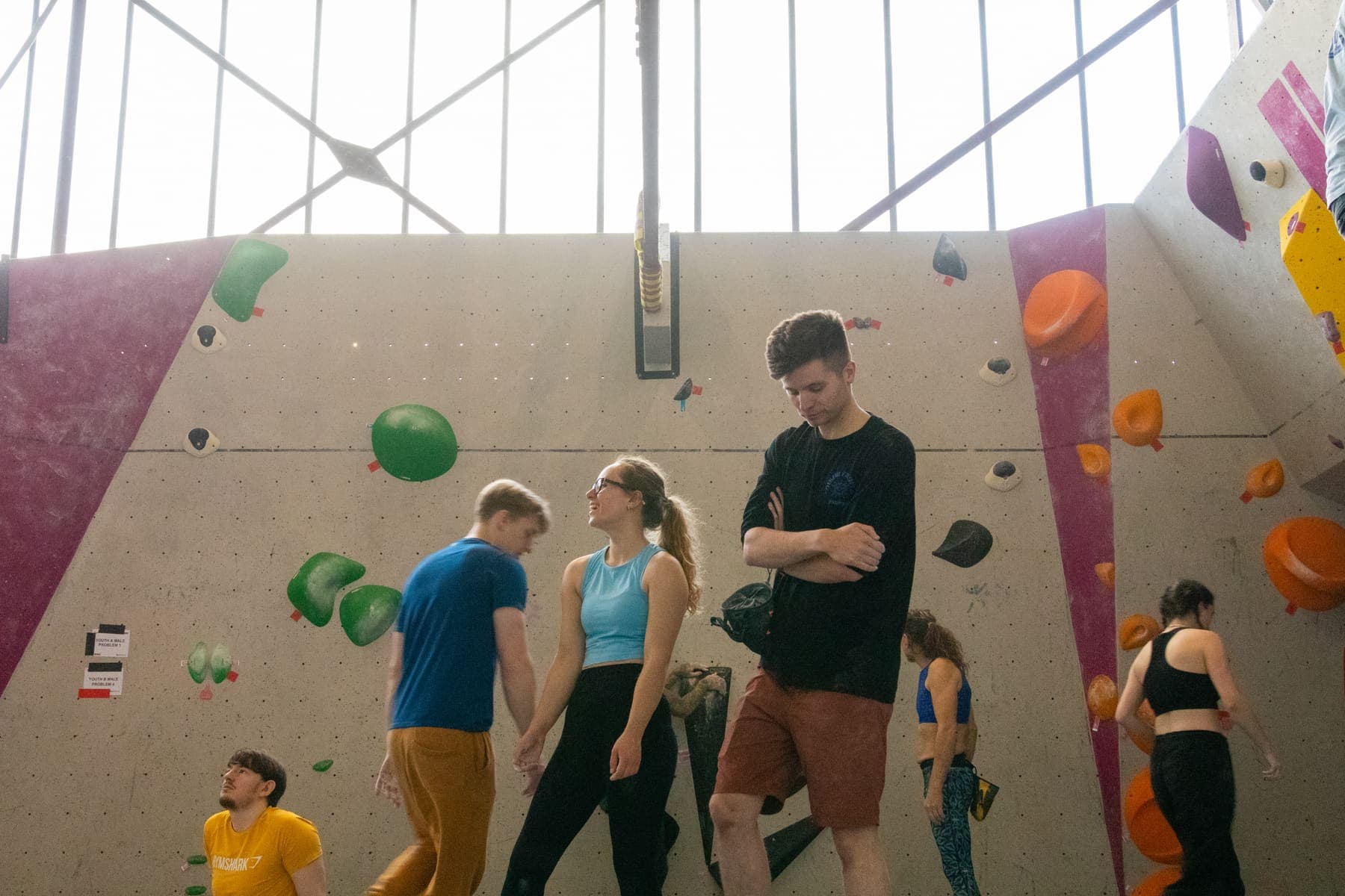 Climbers gathered at the bottom of the competition wall
