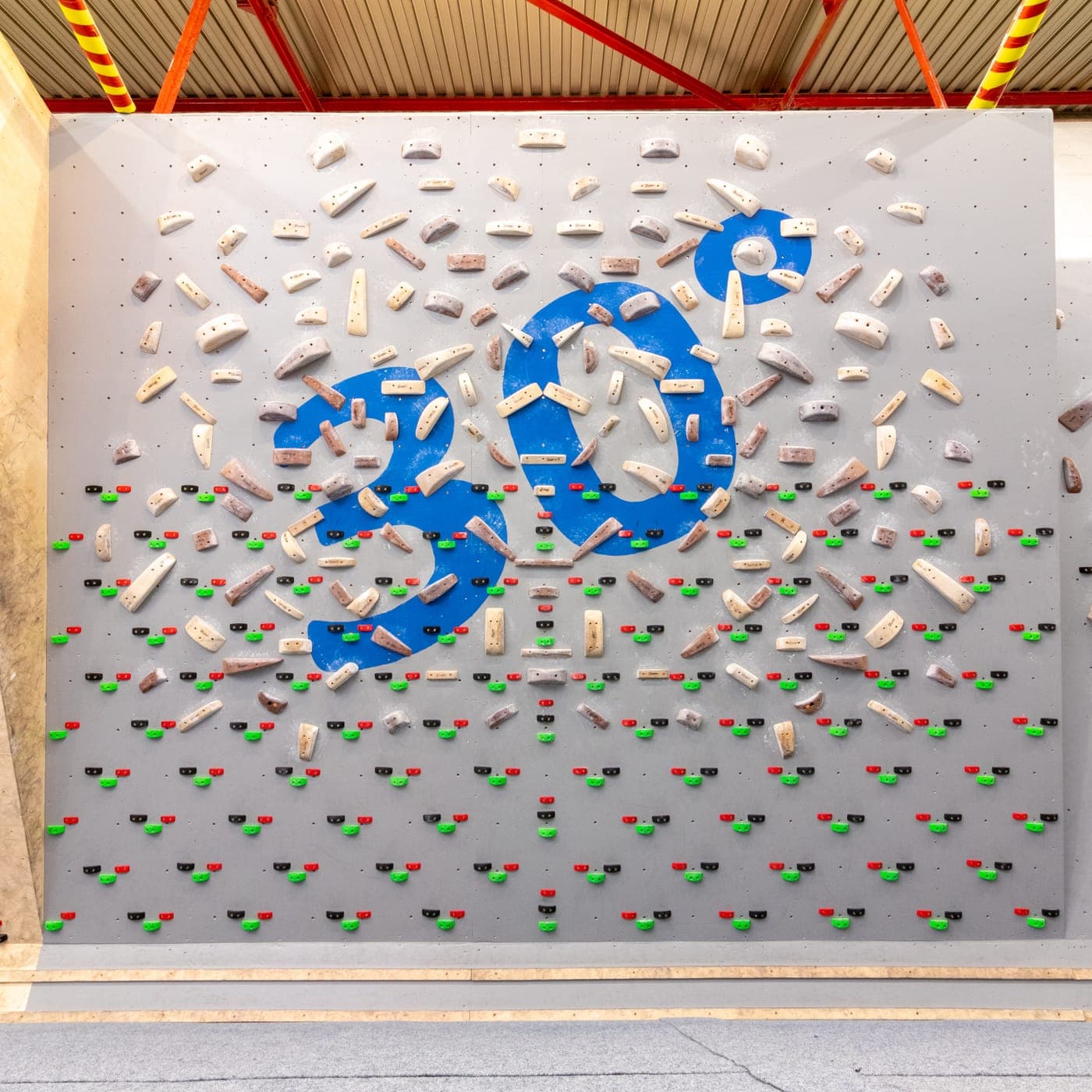 The 30 degree training board, its angle marked out in blue tape among the holds