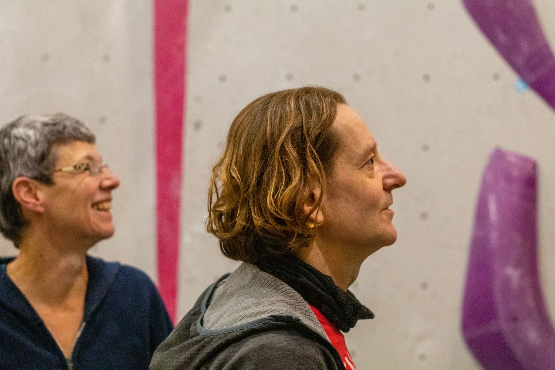 Two climbers sharing a joke at the bottom of the wall