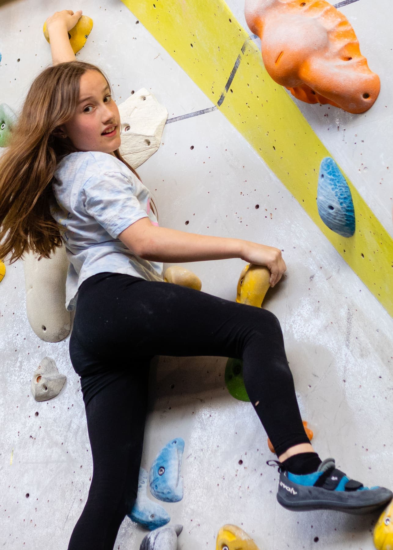 A girl looking back from the wall with a smile